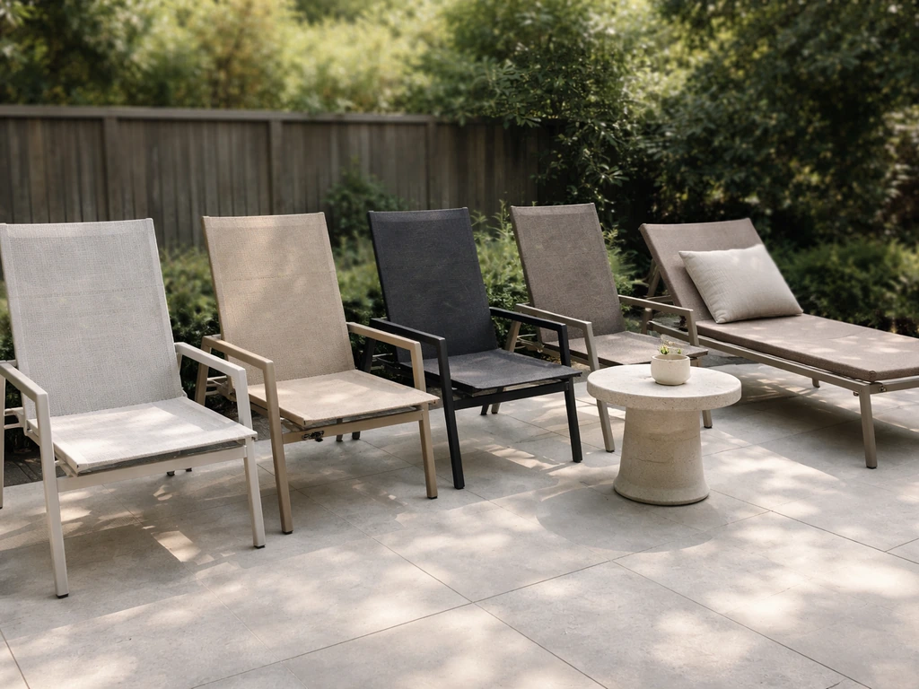 Sunlit patio with sling chairs and a chaise lounge lined up, showing woven sling fabric texture.