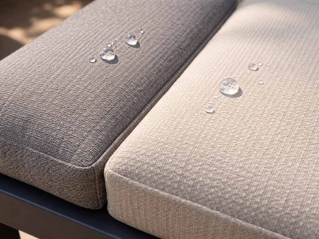 Close-up of olefin outdoor cushion fabric with visible weave and water droplets beading on the surface